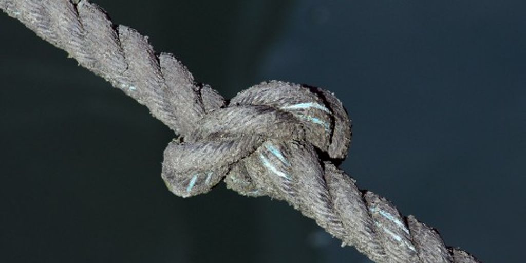 fisherman tying a tuna knot on a boat